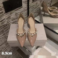 Women's patent leather pointed toe high heels with pearl accents on stiletto heel