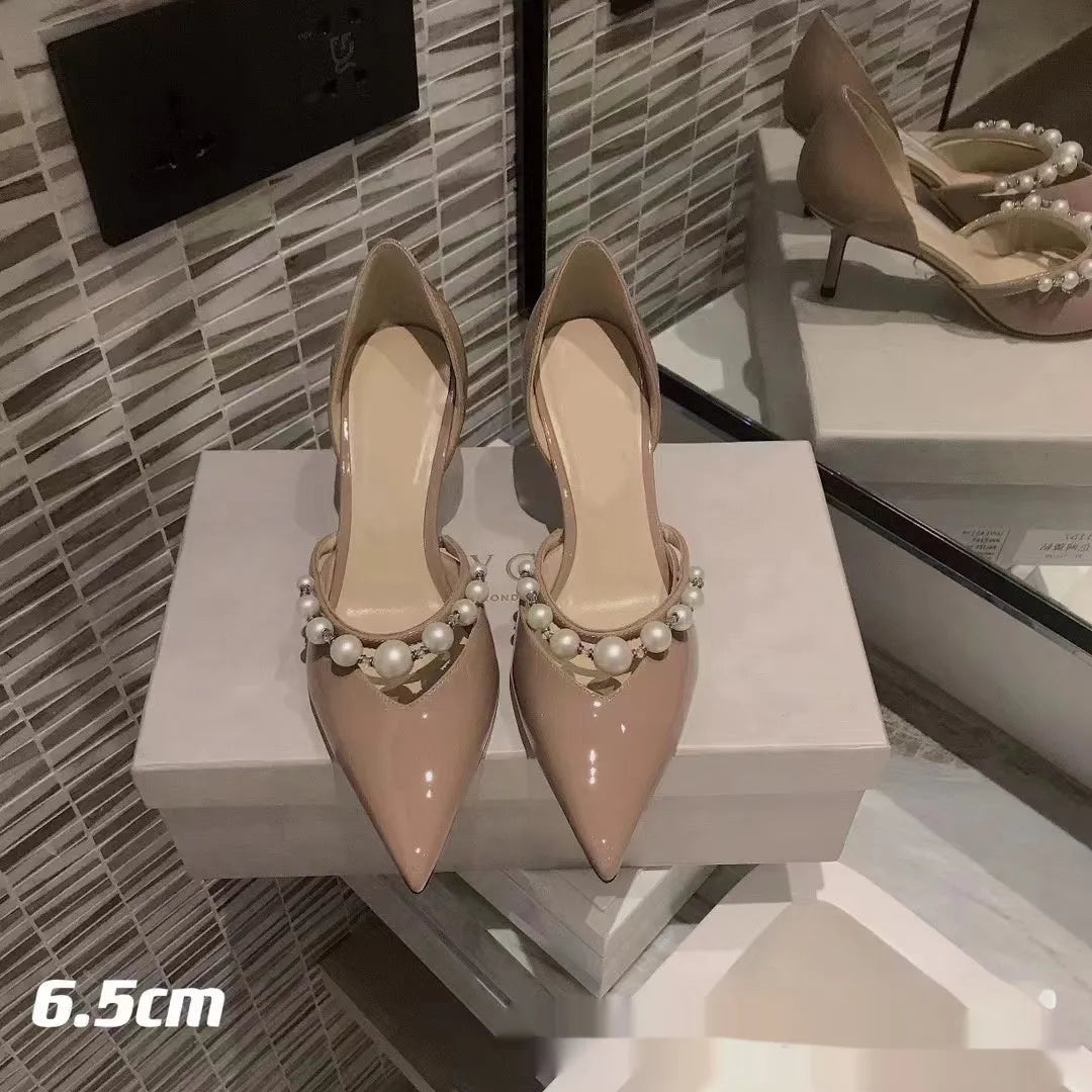 Women's patent leather pointed toe high heels with pearl accents on stiletto heel