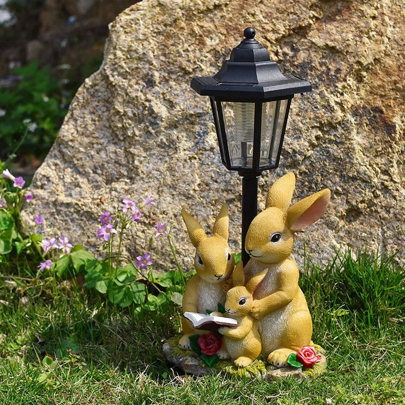 Hexagonal solar garden lamp with decorative resin animal design on grass