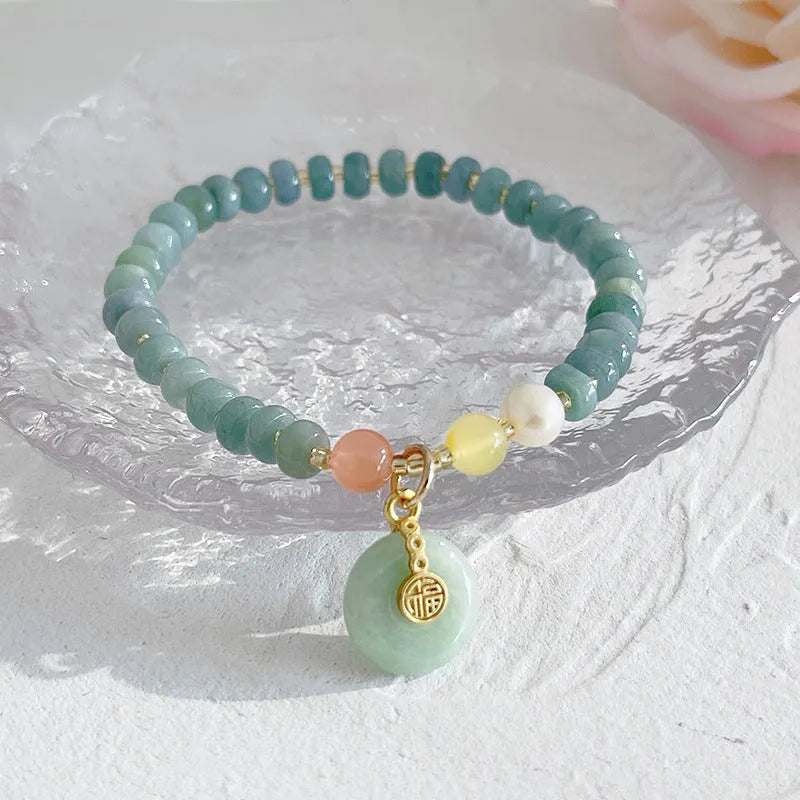 Natural blue water jade bracelet with gourd beads and peace buckle charm on woman's wrist