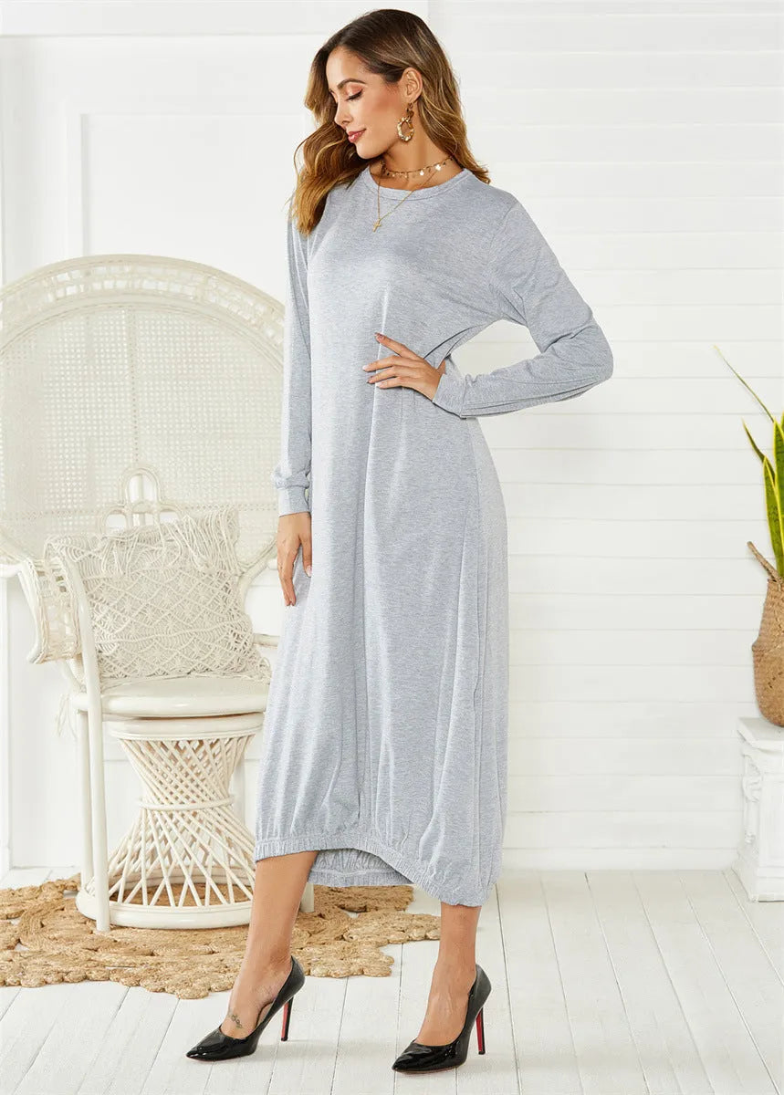 A loose long lantern dress with a lace-up crew neck, shown in grey.