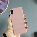 A wine red silicone phone case fitted on an iPhone, showing its slim form and textured surface.