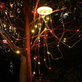 Charging multifunctional camping lantern with warm and colourful light modes on a campsite table