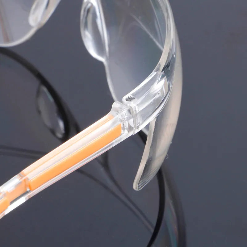 Transparent safety goggles with yellow tinted polycarbonate lenses for lab and welding protection.