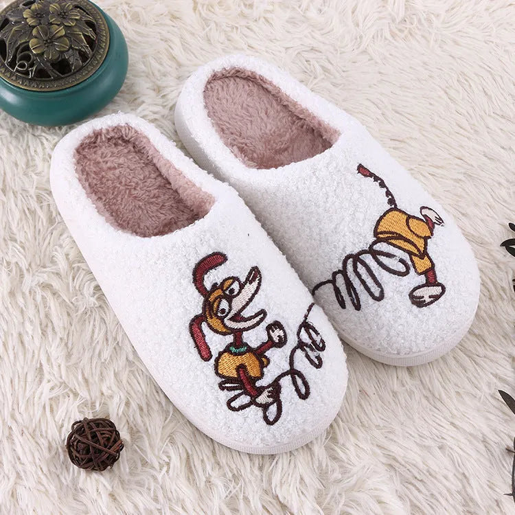 White fluffy slippers with cartoon pattern, rubber sole, and a toe holder design.