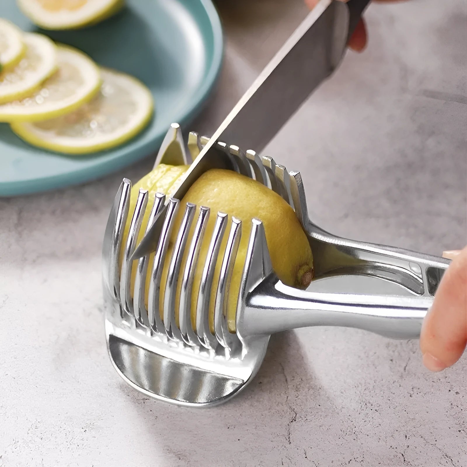 Silver plastic lemon slicer kitchen gadget with ergonomic handles for cutting citrus fruits
