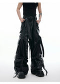 Men's black loose-fit trousers with quilted panels, heavy stitching, and multiple pockets.