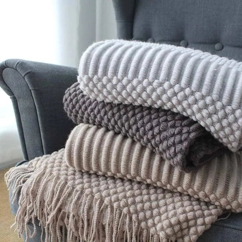 Small light grey polyester nap blanket folded, showing its texture and 127x170 cm size.