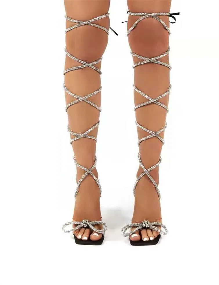 Plus size strappy sandals with rhinestone detail on black background showing square toe and heel