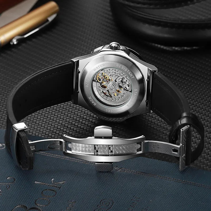 Automatic diamond studded skeleton men's watch with white shell case and blue dial on leather strap.