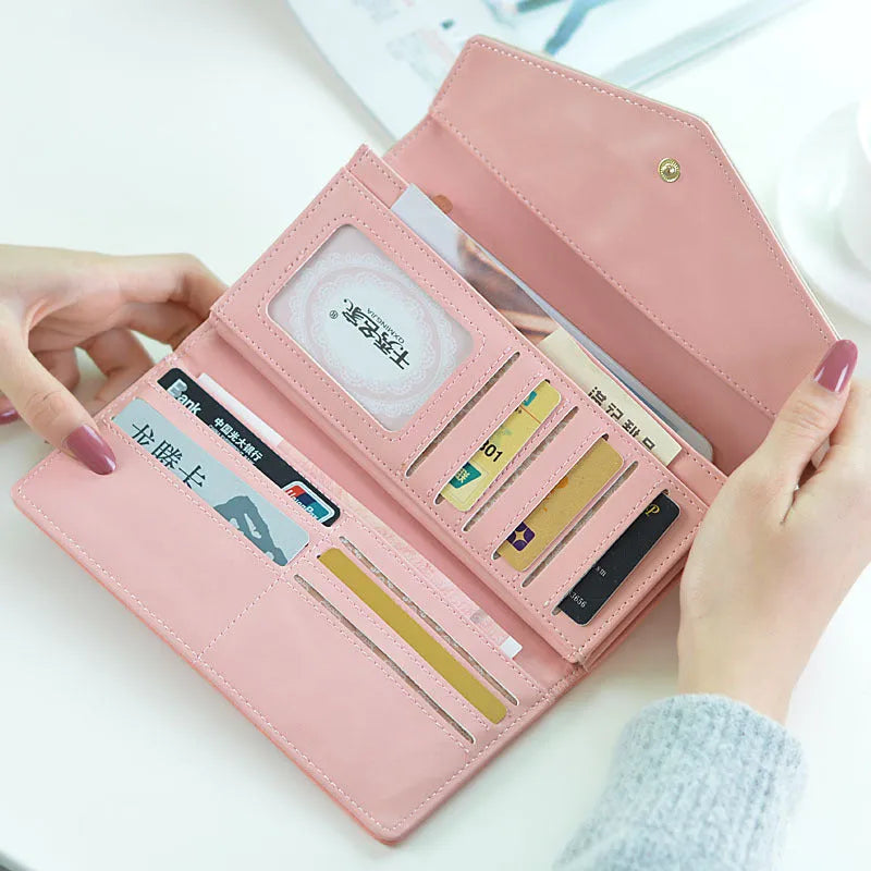 Women's large capacity three fold student wallet in PU leather with buckle closure, shown in multiple colours.