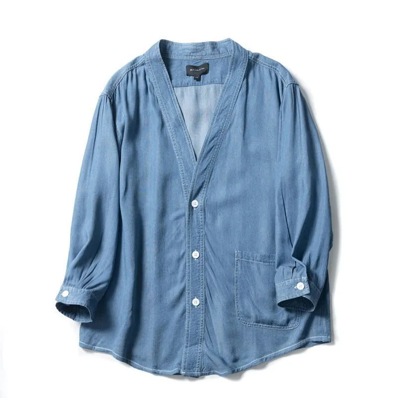 Men's dark blue denim coat with three-quarter sleeves and V-neck collar showing front pocket detail