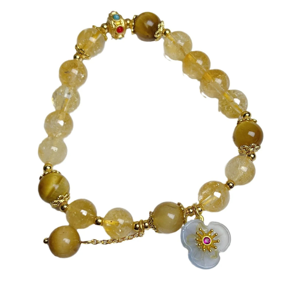 Golden yellow citrine crystal bracelet with flower and tassel detail for women.