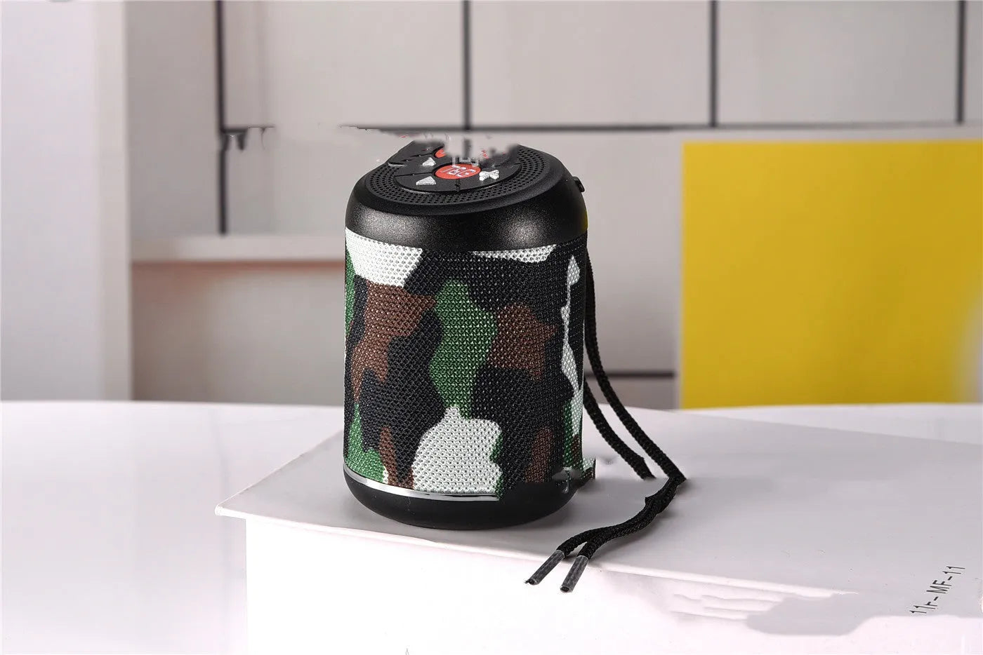 Portable outdoor Bluetooth subwoofer in multiple colours showing control buttons and speaker grille.