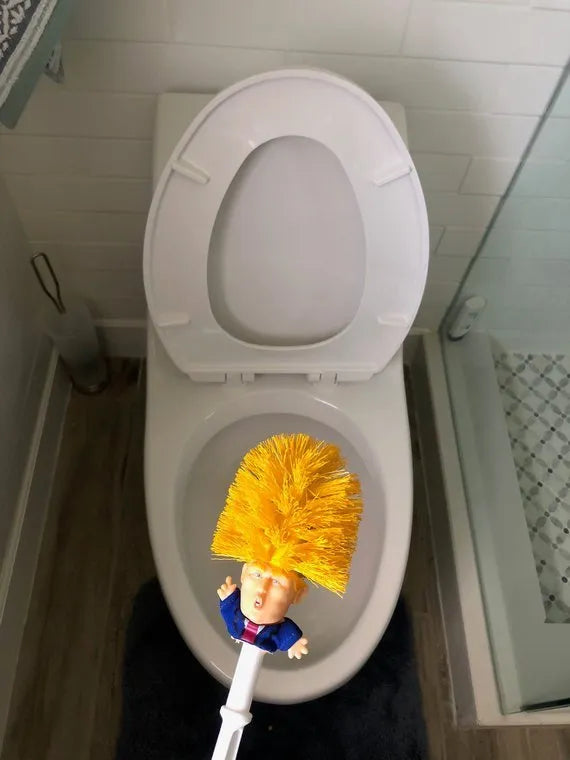 Yellow plastic Donald Trump novelty toilet brush with hanging slot.