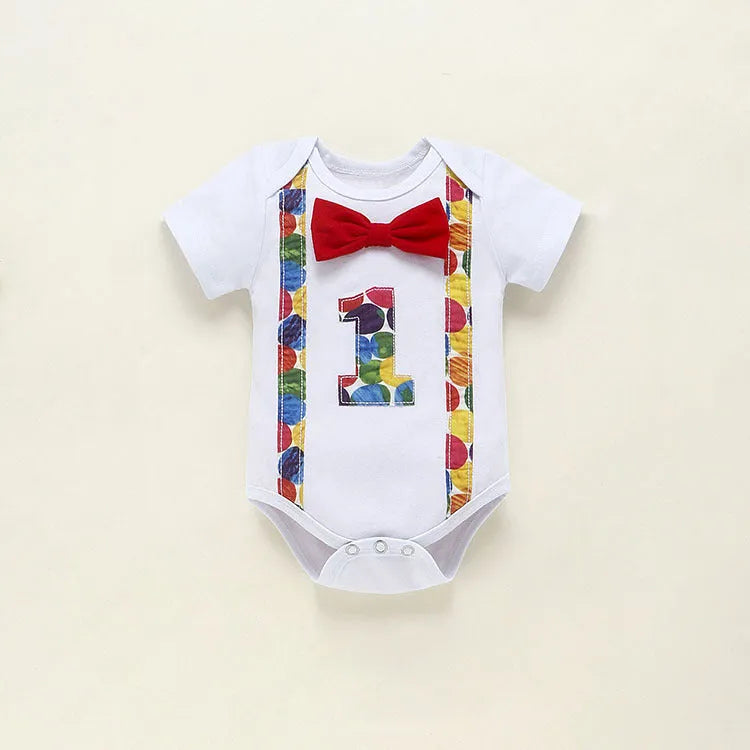 Baby wearing a blue cotton romper shorts with dinosaur print and straps.