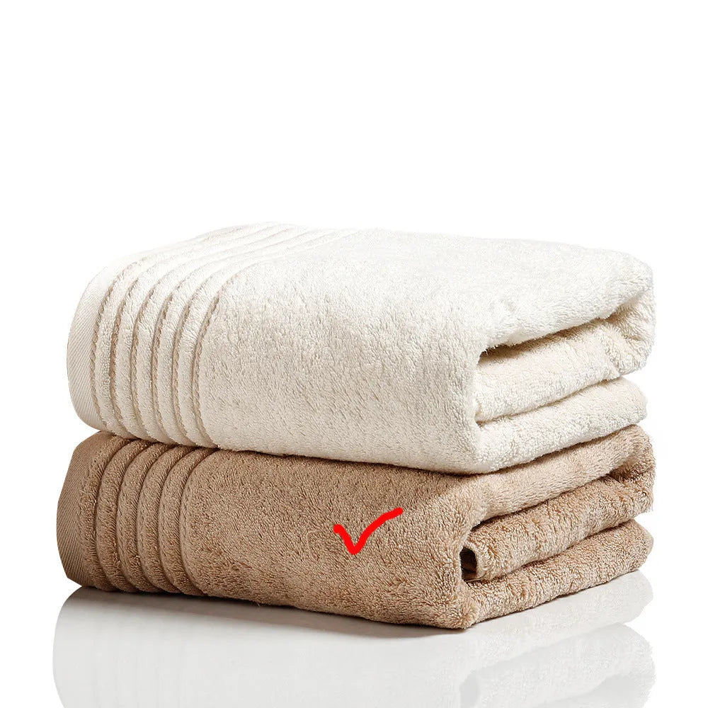 Beige and brown cotton bath towel set showing large bath towel, hand towel, and small face cloth.