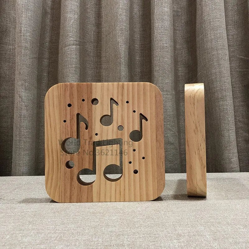 Natural pine wood cube LED atmosphere lamp with warm white glow on a desk.