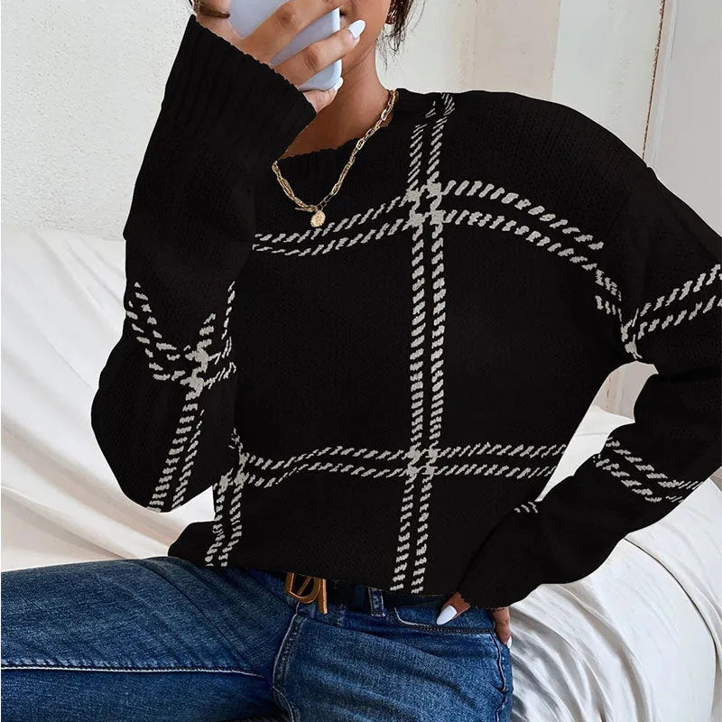 Women's loose fit crew neck sweater in a colour-block plaid pattern with apricot, black, beige, red, and green stripes.