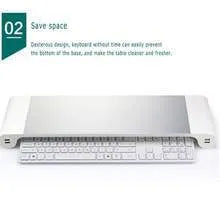 Silver and black computer monitor stand with USB charging ports and hidden keyboard storage compartment