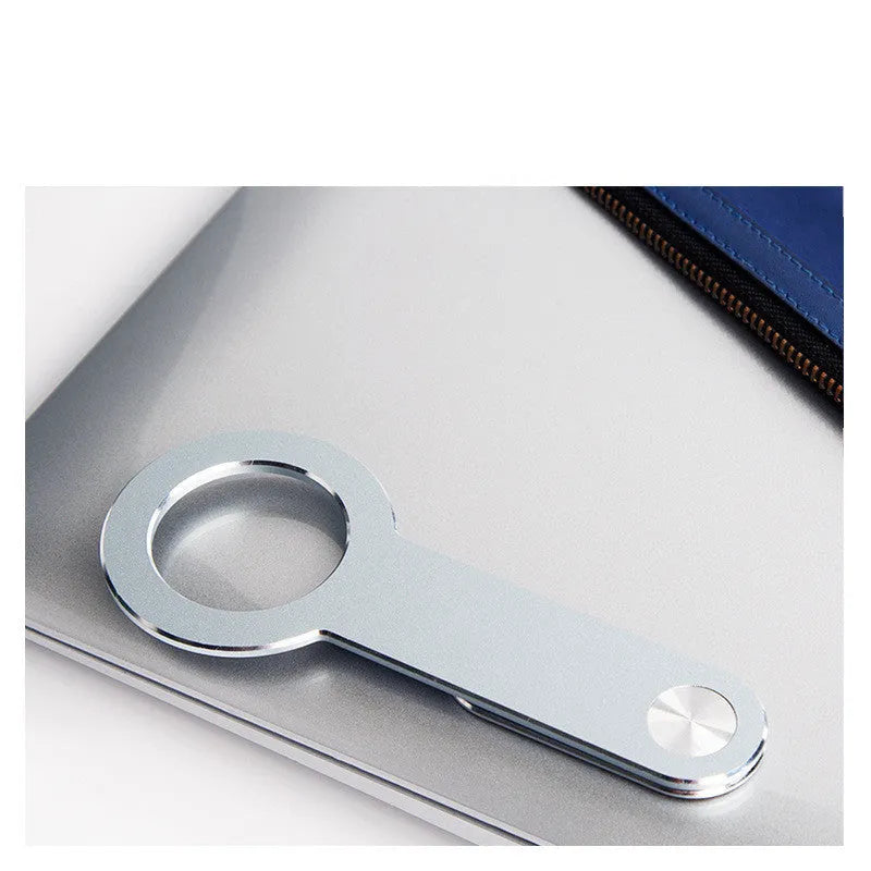 Metallic silver aluminium alloy magnetic phone holder for iPhone on a desk.