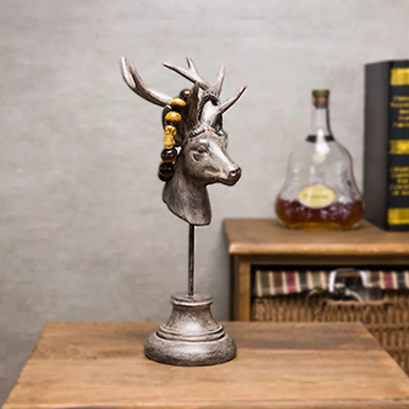 A tall black resin animal sculpture ornament for home decoration on a wooden surface.