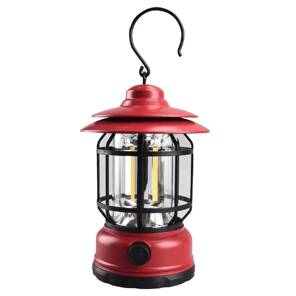 Dark green portable camping lantern with head lamp function on a table