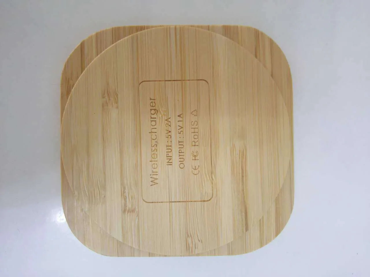 Square wooden bamboo 5W Qi wireless charger on a surface