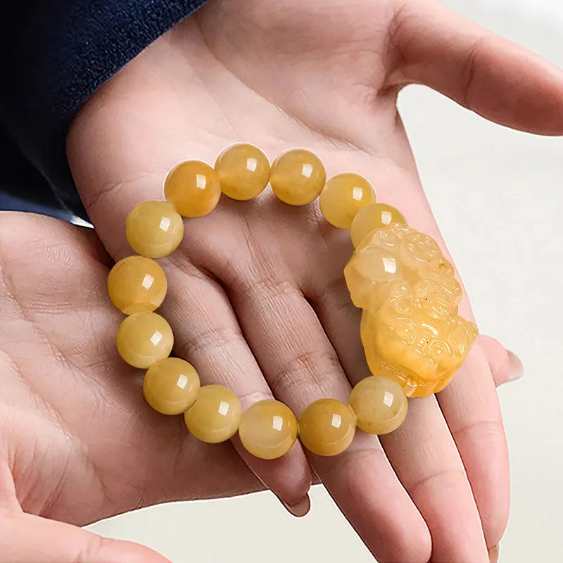 Golden thread jade bracelet with carved money motif showing detailed surface texture and jade beads