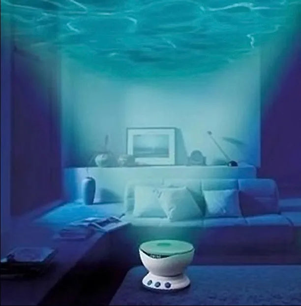 Blue ocean theme LED projection lamp for children's rooms on a wooden surface.