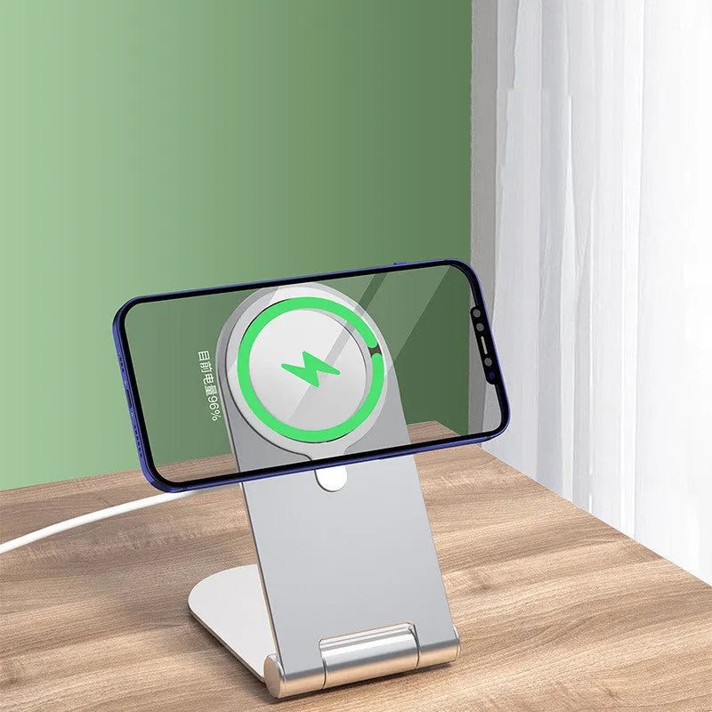 Silver vertical adjustable magnetic phone bracket for iPhone 12 shown in a car and on a desk.
