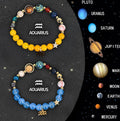 Two natural stone beaded bracelets with zodiac sign charms on a textured background.