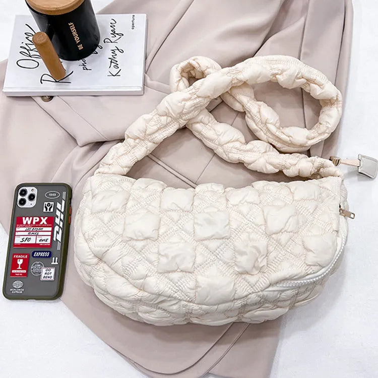 Women's solid colour nylon messenger bag with long shoulder strap shown in beige.