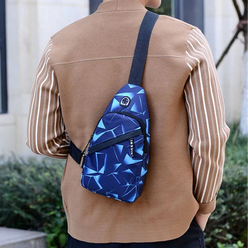 Medium blue crossbody chest bag for men with a visible earphone hole and zipper opening.