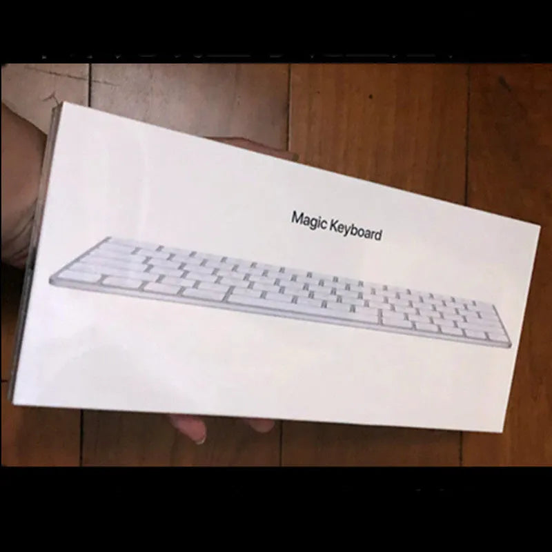 Genuine white Apple Bluetooth G6 wireless keyboard with ultra-thin metal build on a desk.