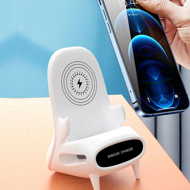 White wireless charging phone stand on a desk, charging a mobile phone at a viewing angle.