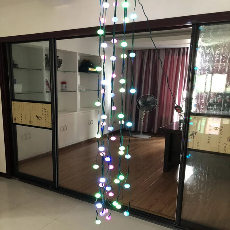 64 LED Christmas tree light string stretched out showing its 1.8 metre length and button control for dimming and colours.