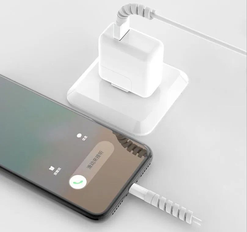 Plastic charging cable protector in various colours, shown next to a USB cable.