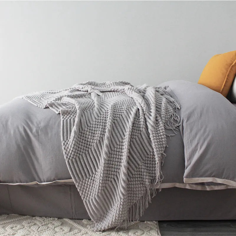 Small light grey polyester nap blanket folded, showing its texture and 127x170 cm size.