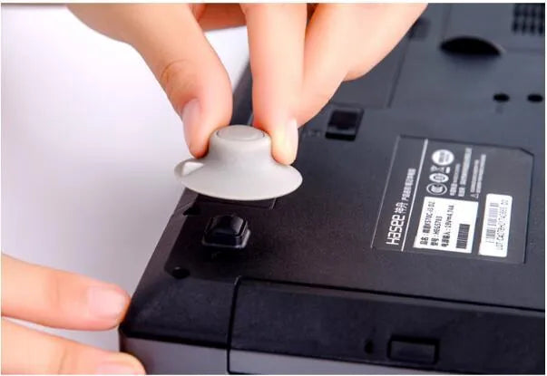 Four grey plastic non-slip cooling pads for laptops, shown in two different sizes.