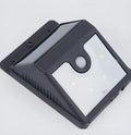 Two white solar-powered LED security lights with ground stakes for outdoor use.