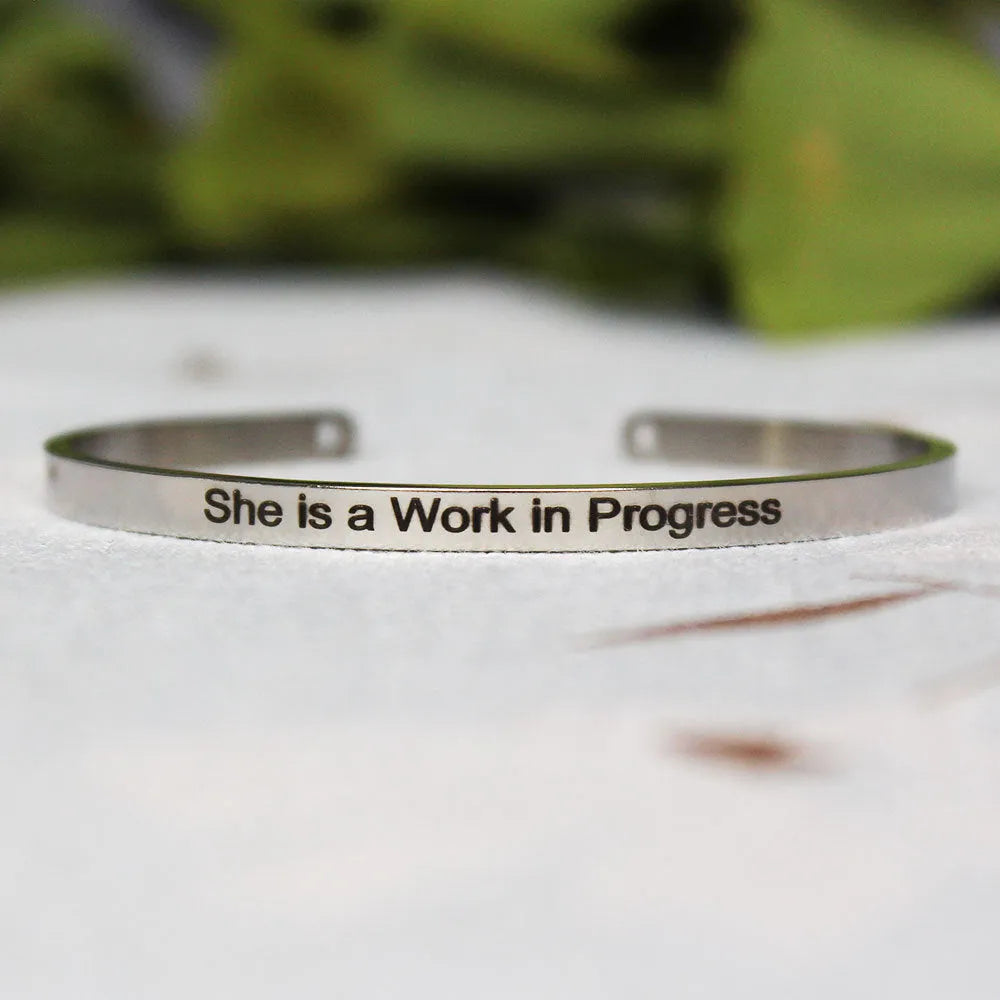 Silver customisable stainless steel bracelet with laser engraved text and adjustable fit on neutral background