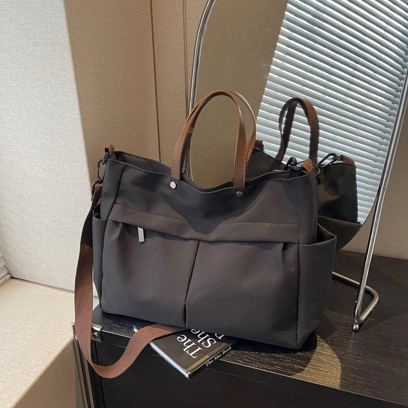 Nylon crossbody tote bag for women in black, shown with crossbody strap.
