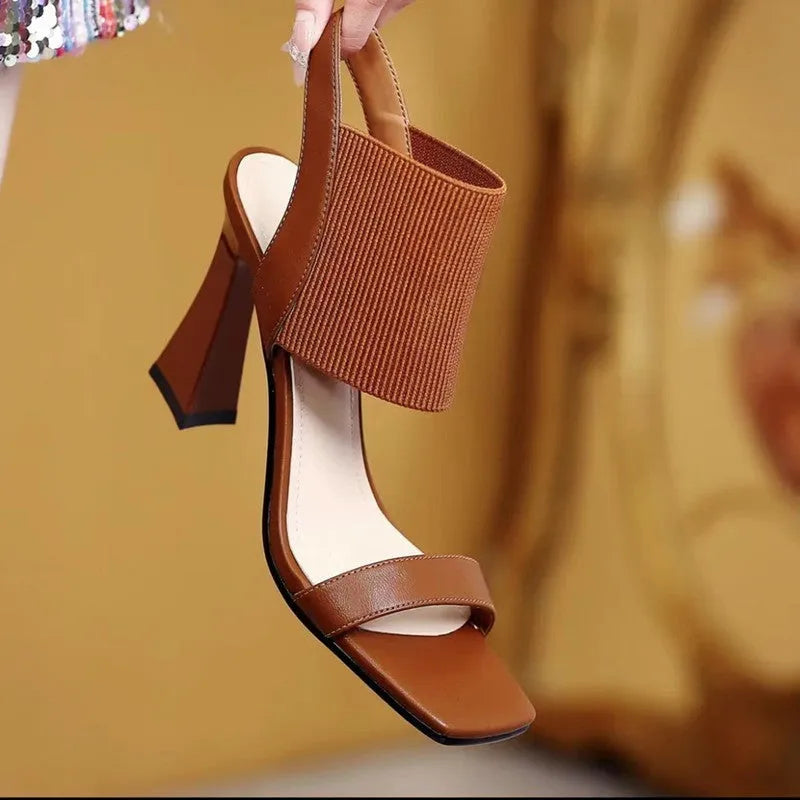 Women's black high heel sandals with elastic straps and rubber sole