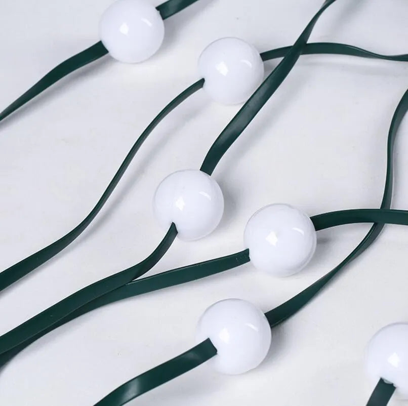 64 LED Christmas tree light string stretched out showing its 1.8 metre length and button control for dimming and colours.