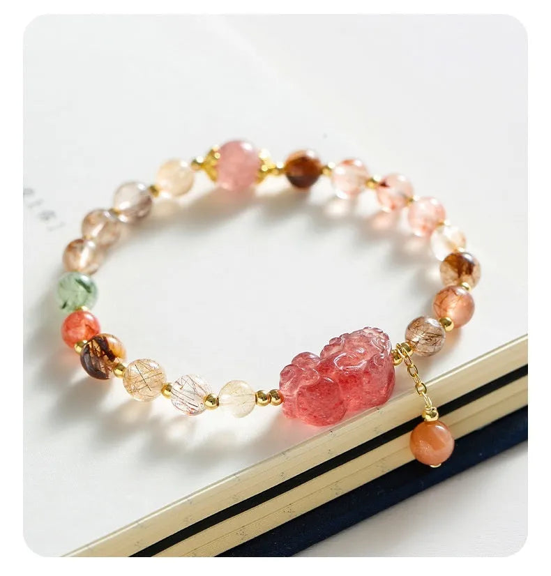 Women's strawberry quartz crystal bracelet with copper construction and pearl detailing in Chinese style design.