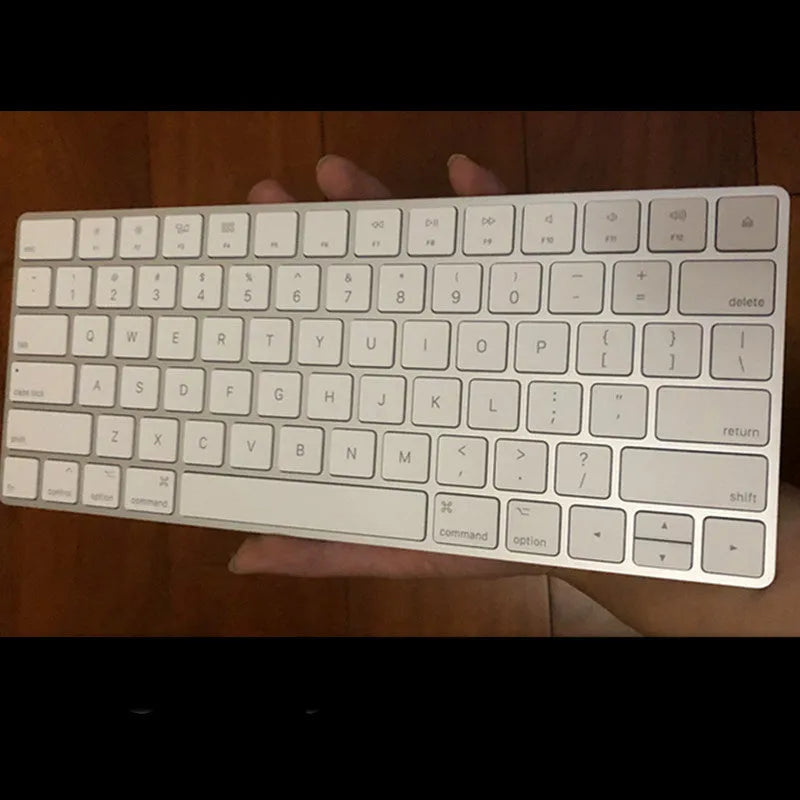 Genuine white Apple Bluetooth G6 wireless keyboard with ultra-thin metal build on a desk.