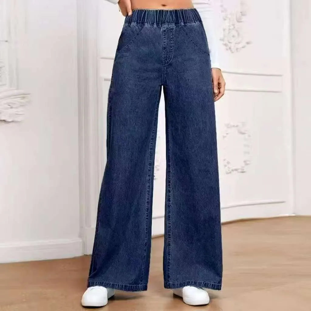 Light blue washed wide-leg straight jeans on a hanger, showing mid waist and zip fly detail.
