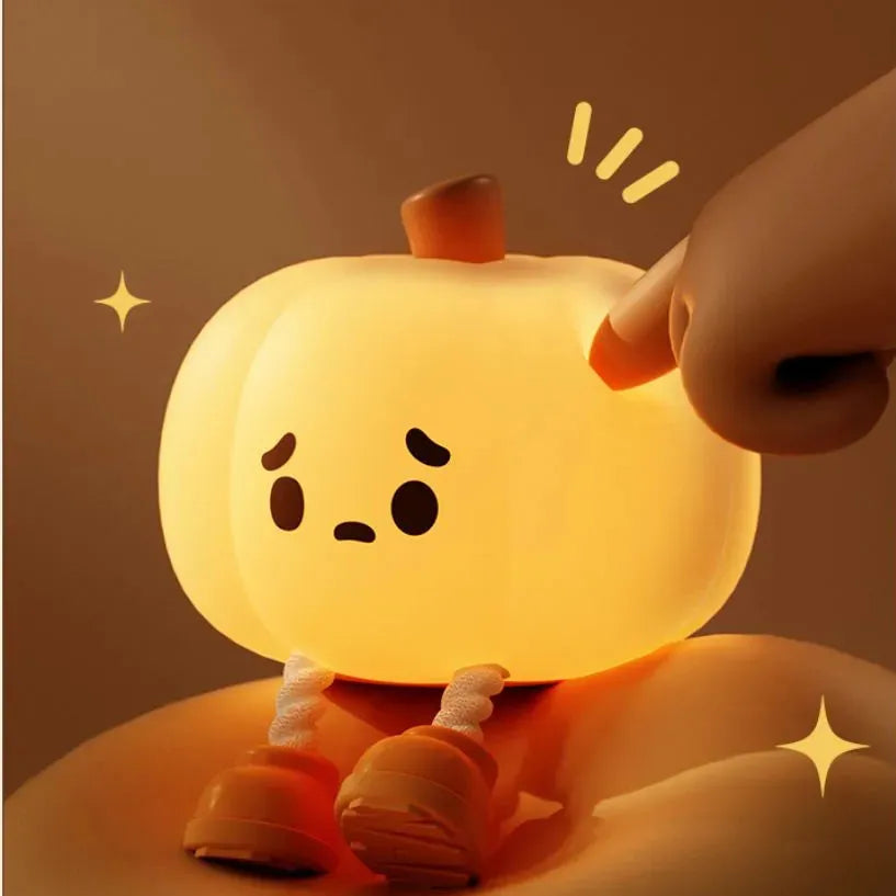 Soft orange silicone pumpkin-shaped night light with a warm glowing LED centre