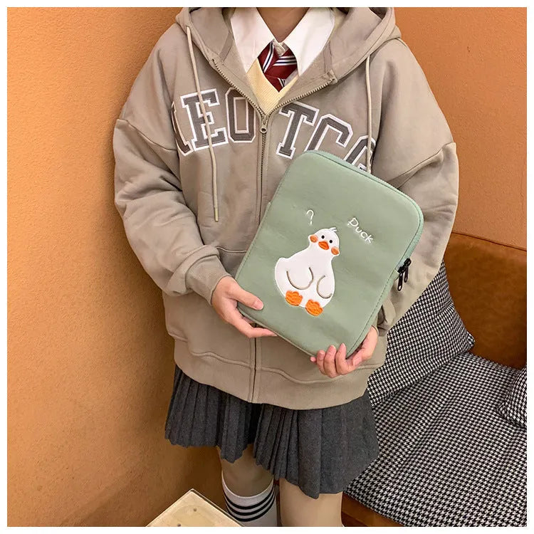 Blue cotton tablet case with embroidered cartoon duck design and zipper closure.
